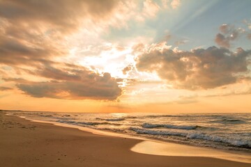Fototapeta na wymiar Beautiful sunset over a sandy seaside beach. Baltic Sea (Morze Bałtyckie), Poland.