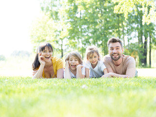 Family lying down in grass