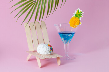 A brain that relaxes on a lounger and drinks a cocktail.