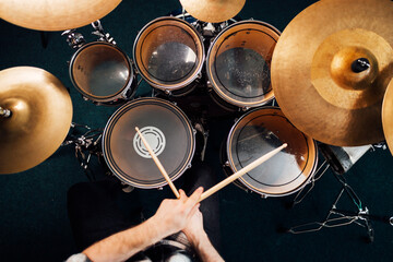 Drummer plays drum kit top view
