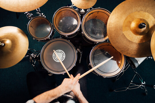Drummer plays drum kit top view - Powered by Adobe