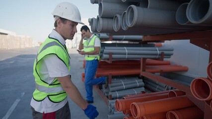 Dissatisfied Caucasian warehouse worker looking at lazy Middle Eastern coworker surfing Internet on smartphone, taking pipe and leaving in slow motion. Employment and unfairness concept - Powered by Adobe