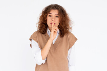 Pretty girl making silence gesture over white background