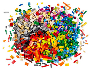 huge pile of stackable plastic toy bricks top view isolated white background.  Colorful texture childhood education and development concept.