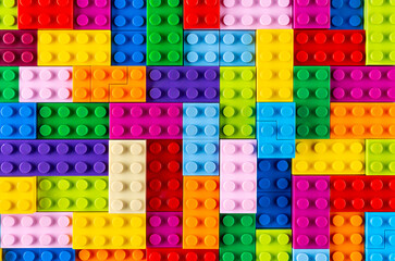 stackable plastic toy bricks top view.  Colorful texture childhood education and development...