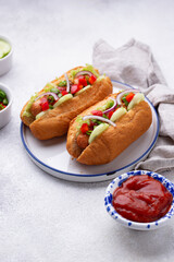 Hot dogs with sausage, sauces and vegetables