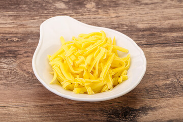 Shredded yellow cheese in the bowl
