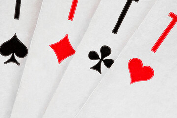 Playing cards ace of hearts, spades, diamonds, clubs, spread out in fan, close-up macro view