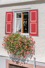 Fototapeta na wymiar blossoming window of traditional house, near Oppenau, Black Forest, Germany