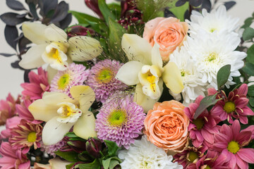 Flower shop concept. Beautiful lovely bouquet of mixed flowers. Roses, orchids, chrysanthemum