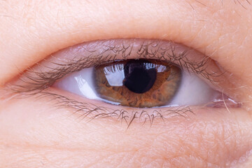 the eye is open. studio lighting. the girl is aged from 30 to 45 years. aging of the skin and eyes....
