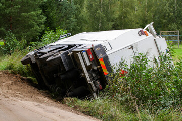 The truck is lying on its side in a car accident