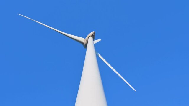 Wind turbine against blue sky, Niagara Region Wind Farm 230 MW of electricity