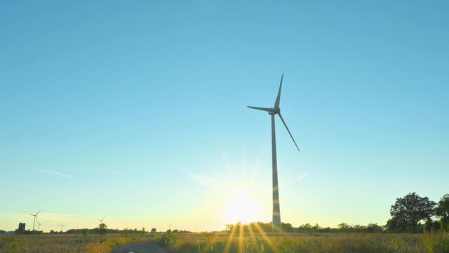 Wind turbines in the field sunset Wind turbine against blue sky, Niagara Region Wind Farm 230 MW of electricity