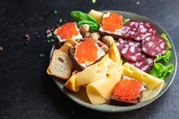 snack plate antipasto caviar, sausage, meat, cheese, nuts, peach, fruit, toast bread appetizers...