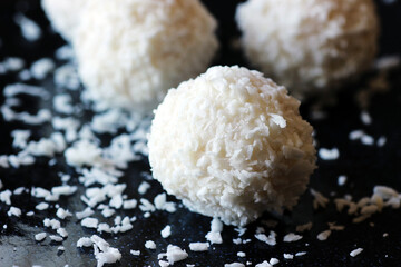 Coconut candies on a black background close up