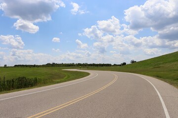Fototapeta premium The winding road in the countryside on a sunny day.