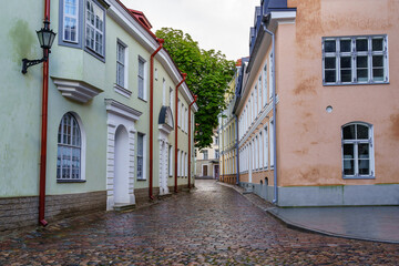 Fototapeta na wymiar Cobbled alley with puddles after raining in Tallinn Estonia.