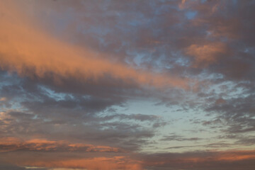 Naklejka na ściany i meble Natural background. Clouds and sky at sunset. Close-up.