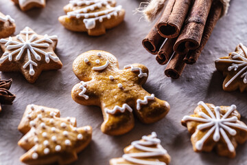 Gingerbread man and other Christmas cookies along with cinnamon