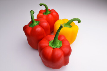Colorful red and yellow peppers paprika background. Fresh juicy bell peppers on a gray background, copy space.