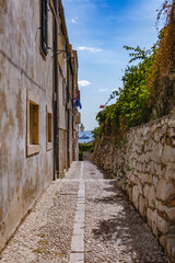 A narrow alley towards the sea at the Old city in Dubrovnik, Croatia