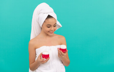 cheerful teen girl in bath tower presenting body cosmetic, skincare