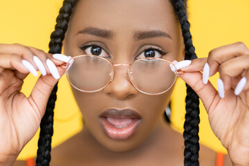 Astonished woman. Omg expression. Vision correction. Shocked Afro model open mouth face in...