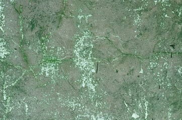 A concrete wall with remnants of green paint .Background
