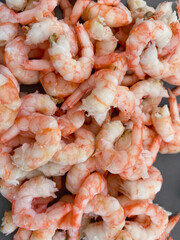 Delicious red and pink freshly peeled Swedish shrimps on a plate. Tasty seafood.