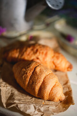 Provence still life with French croissants, rustic watering can and lavender flowers
