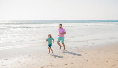 weekend family day. dad and child have fun outdoors. father and son running on sunny summer beach