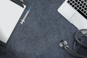 Medical accessories. Doctor stethoscope and syringe, notebook on the desk