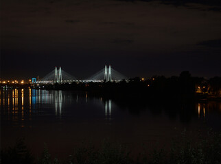 Night landscape of the river, city lights and cable-stayed bridge