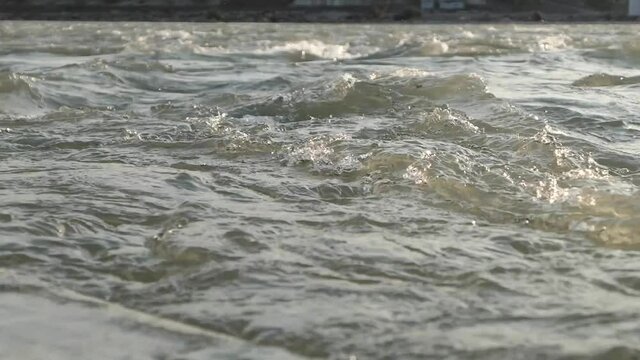 Transparent waves of the Ganges. Fast current near the shore. Clean water in the foothills of the Himalayas