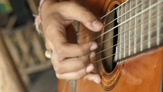 Fingers on the guitar strings. Musical instruments