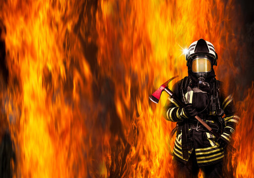 Deutscher Feuerwehrmann steht im Feuer mit Feuerwehr-Axt