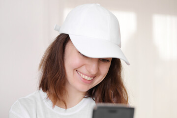 Female model wearing a white baseball cap. White cap mockup, template for picture, text or logo....