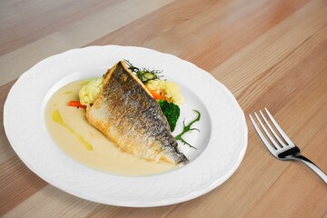 Traditional food tasty fish with vegetables on a plate
