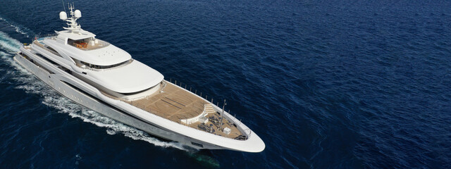 Aerial drone ultra wide panoramic photo of beautiful modern super yacht with wooden deck cruising...