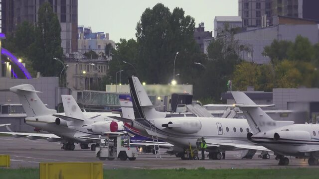 Maintenance and refueling of business jets standing on the airfield after landing