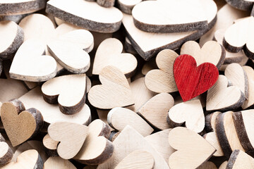 Fototapeta premium Wooden hearts, one red heart on the heart background..