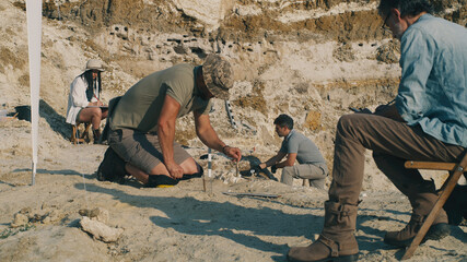 Team of archaeologists excavating fossils