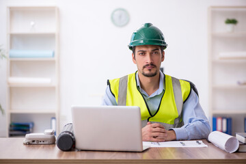 Young male architect working in the office