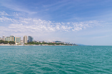 Sochi city coast panorama at summer. View from yacht. Black sea, Russia.