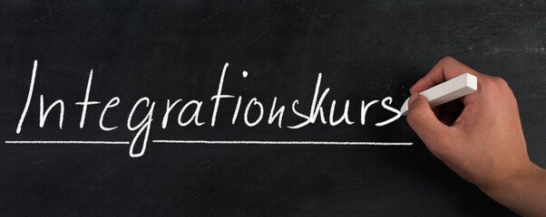 The words integration course are standing in the german language on a blackboard