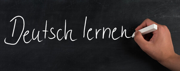 The words learn germanare standing in the german language on a blackboard