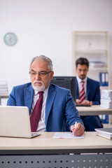 Two male colleagues working in the office