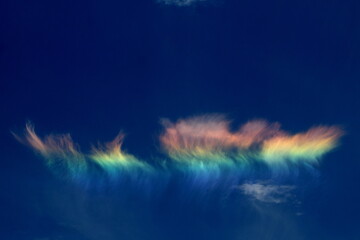 Sundog clouds with colors of the rainbow with blue sky