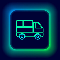 Fototapeta premium Glowing neon line Delivery truck with cardboard boxes behind icon isolated on black background. Colorful outline concept. Vector